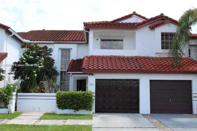 mediterranean / spanish home with a garage