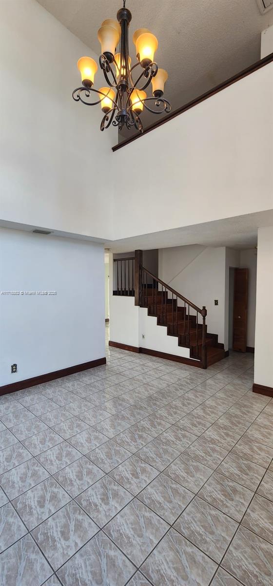 interior space with an inviting chandelier and a towering ceiling