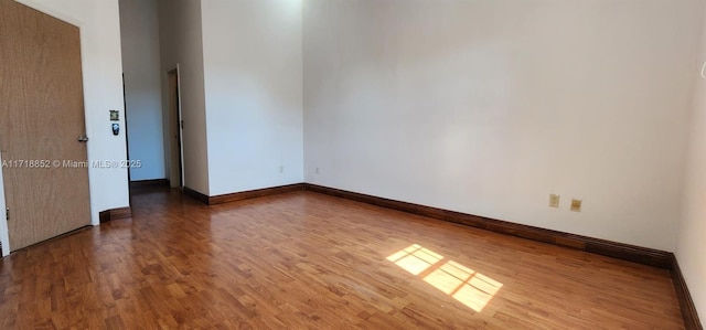 spare room featuring wood-type flooring