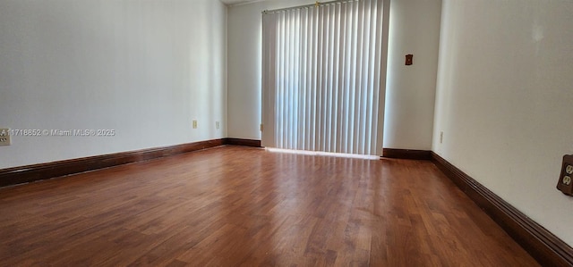 unfurnished room with wood-type flooring