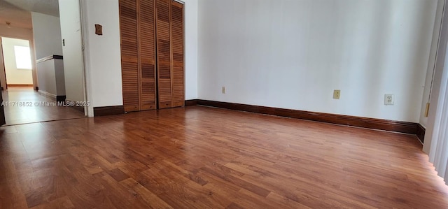 unfurnished bedroom with dark hardwood / wood-style floors