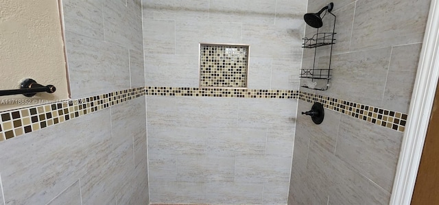 bathroom with tiled shower