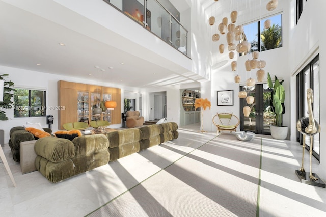 living room with french doors and a high ceiling