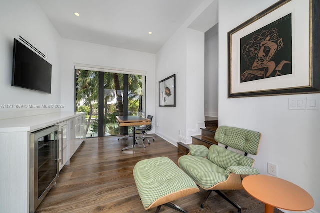 sitting room featuring wine cooler, indoor bar, and dark hardwood / wood-style flooring