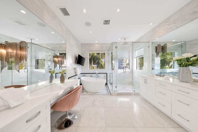 bathroom with tile walls, vanity, and shower with separate bathtub