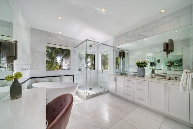 bathroom featuring tile walls, separate shower and tub, and vanity