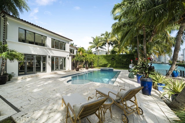 view of swimming pool with an in ground hot tub and a patio