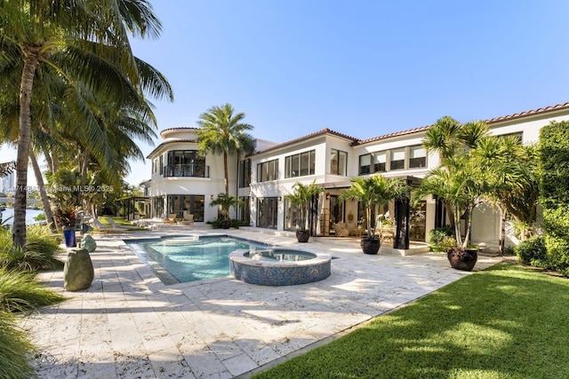 view of swimming pool featuring a patio area and an in ground hot tub