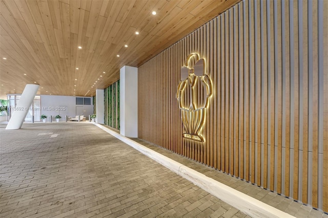 corridor with wood walls and wooden ceiling