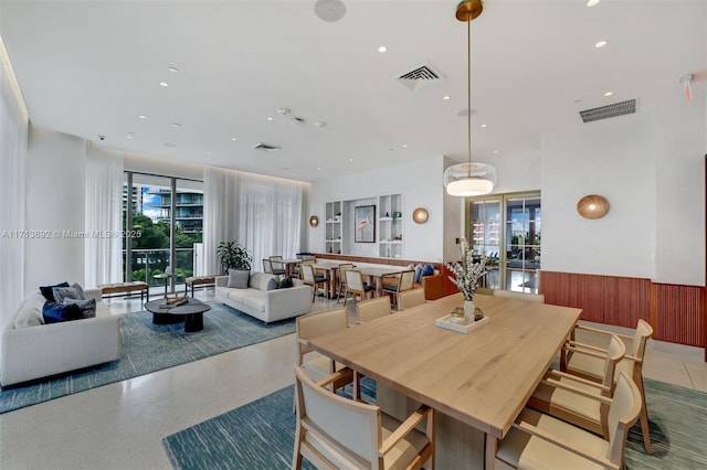 dining space featuring wood walls