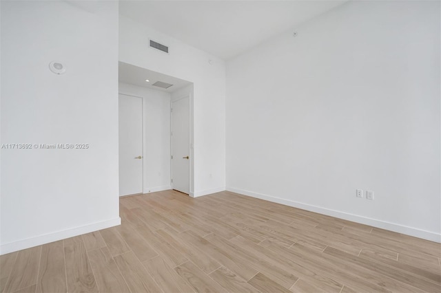 spare room with light hardwood / wood-style flooring