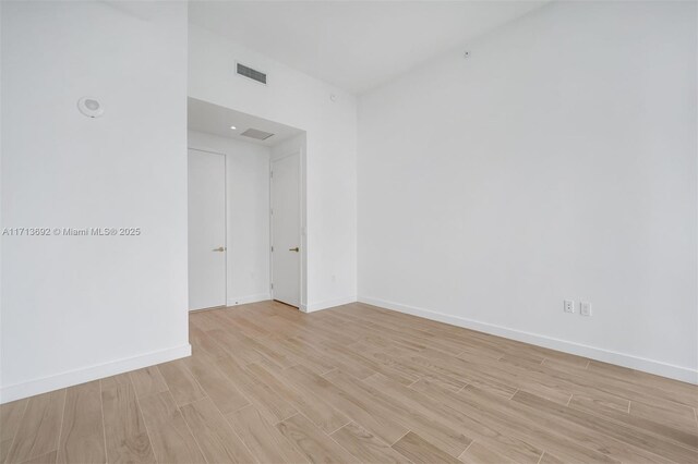 spare room with light hardwood / wood-style flooring