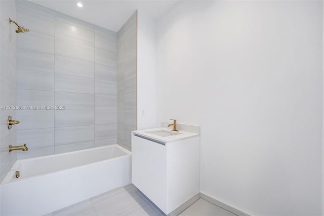 bathroom with tile patterned floors, vanity, and tiled shower / bath combo