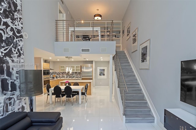 interior space featuring tile patterned flooring and a towering ceiling