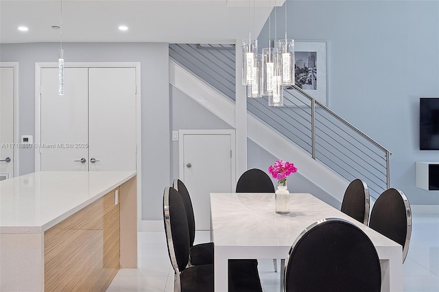 dining room with an inviting chandelier and light tile patterned floors