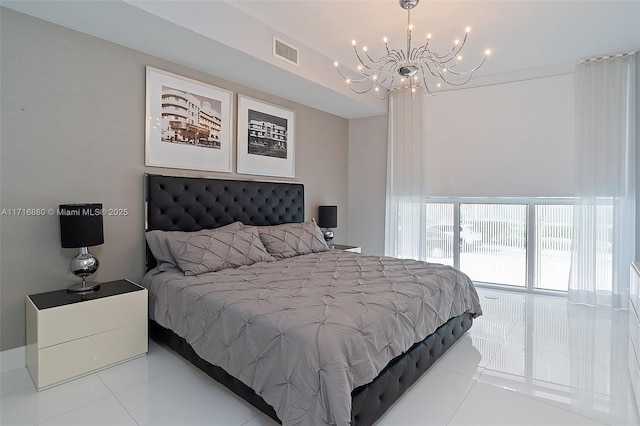 tiled bedroom with a chandelier