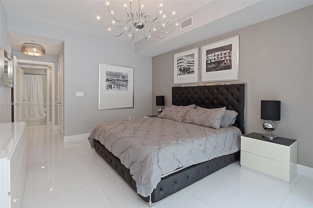 bedroom with light tile patterned floors and a notable chandelier