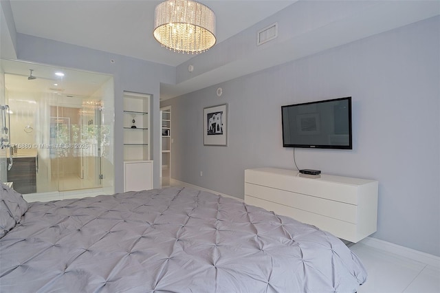 unfurnished bedroom featuring ensuite bath and a chandelier