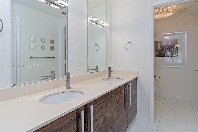 bathroom with vanity, toilet, and tile patterned flooring