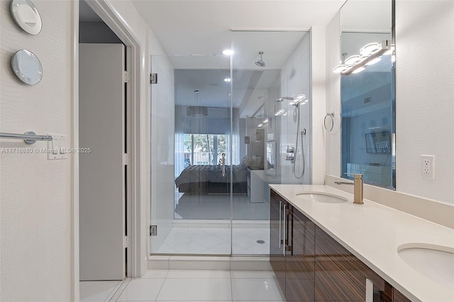 bathroom with tile patterned floors, a shower with shower door, and vanity