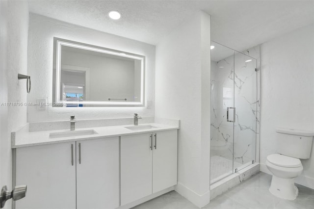 bathroom featuring a textured ceiling, vanity, an enclosed shower, and toilet