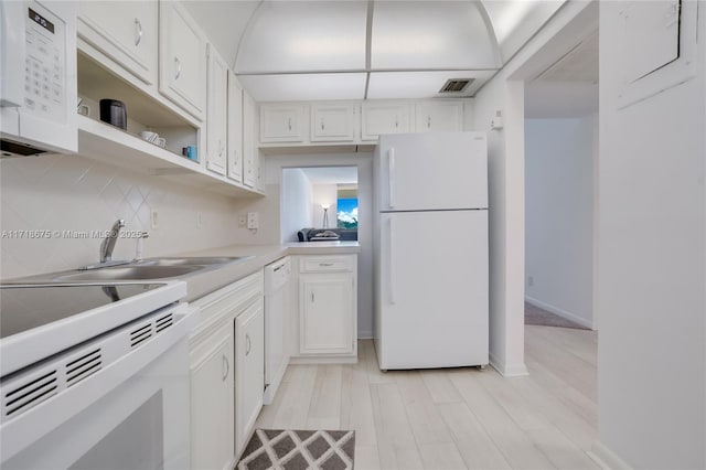 kitchen featuring decorative backsplash, white appliances, sink, light hardwood / wood-style flooring, and white cabinetry