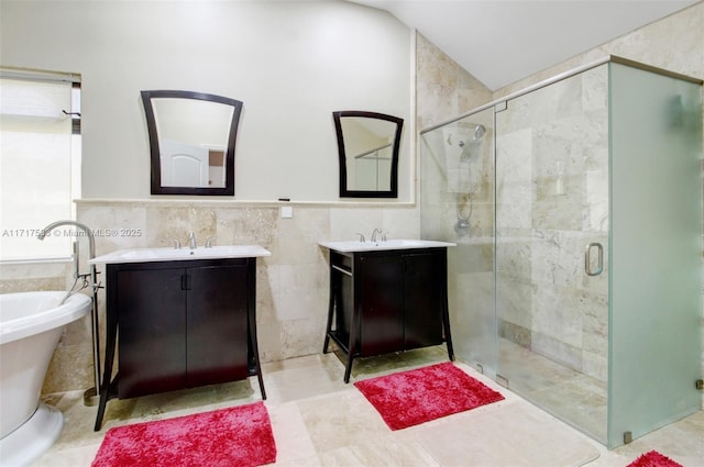 bathroom with vanity, plus walk in shower, and tile walls