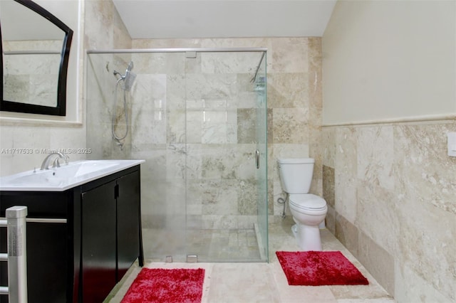 bathroom with vanity, toilet, tile walls, and walk in shower