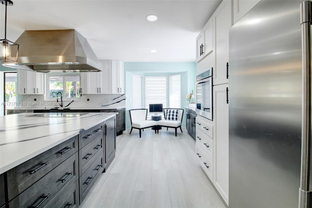 kitchen featuring decorative light fixtures, white cabinetry, and appliances with stainless steel finishes