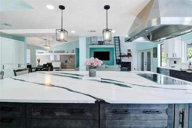 kitchen featuring pendant lighting, a center island, vaulted ceiling, island range hood, and white cabinetry