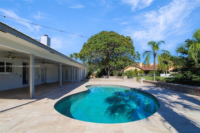 view of swimming pool with ceiling fan and a patio