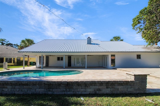 view of pool with french doors, ceiling fan, and a patio area