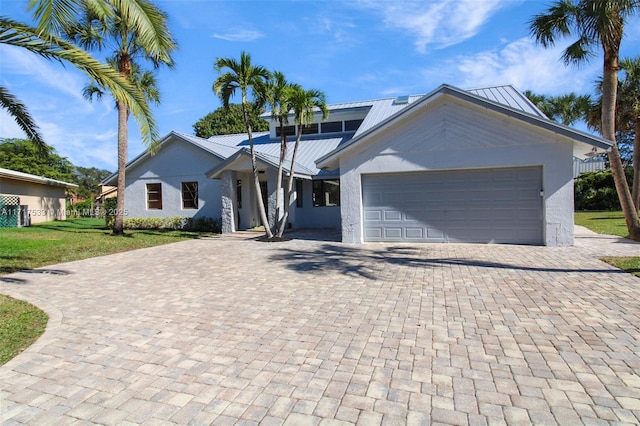 view of front of house with a garage and a front lawn