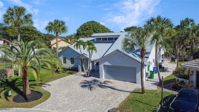 view of front of property featuring a garage and a front yard