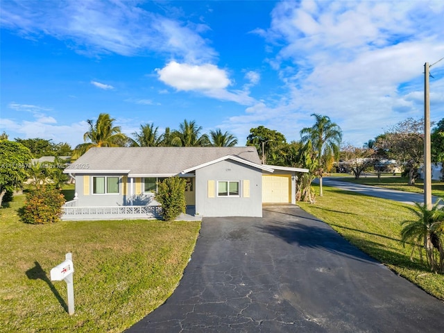 single story home featuring a garage and a front lawn