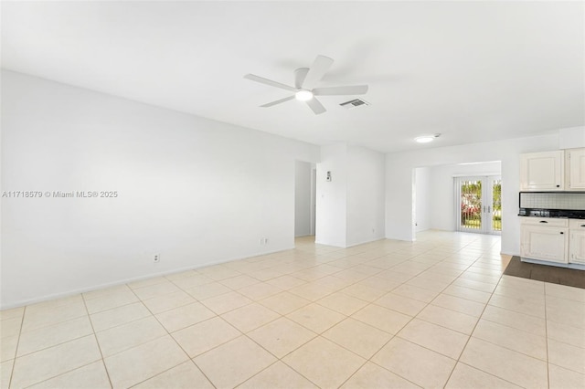 spare room with french doors, ceiling fan, and light tile patterned flooring