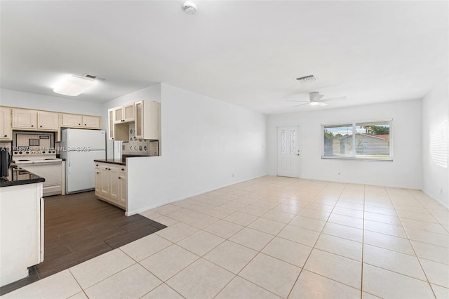 kitchen featuring ceiling fan, white appliances, cream cabinets, and light tile patterned floors