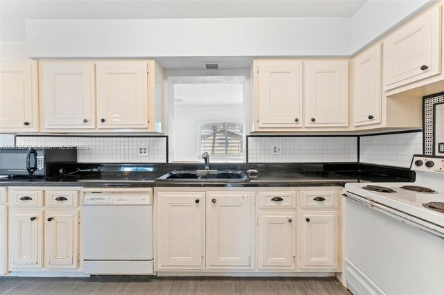 kitchen featuring tasteful backsplash, white appliances, sink, and light hardwood / wood-style flooring