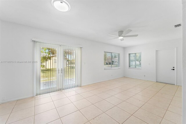 unfurnished living room with light tile patterned flooring and ceiling fan with notable chandelier