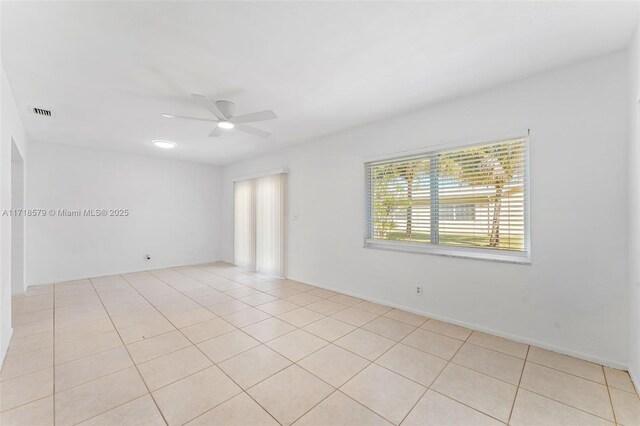 spare room with light tile patterned floors and ceiling fan