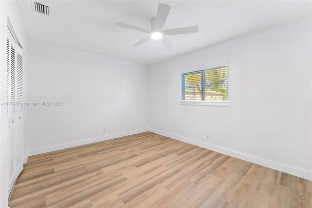 tiled empty room with ceiling fan