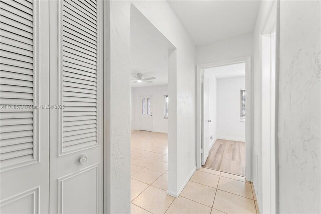 hallway featuring light tile patterned flooring