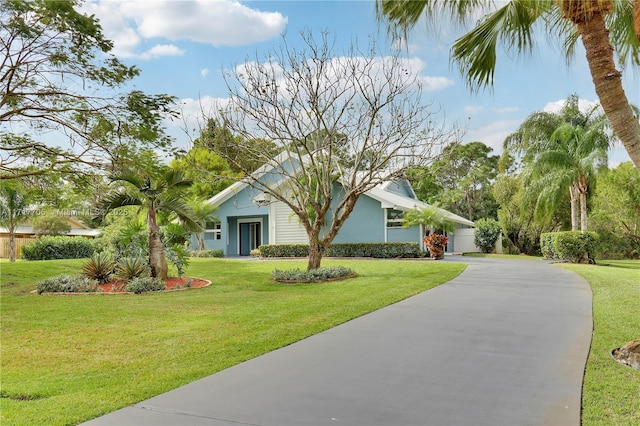 view of front of house with concrete driveway and a front yard