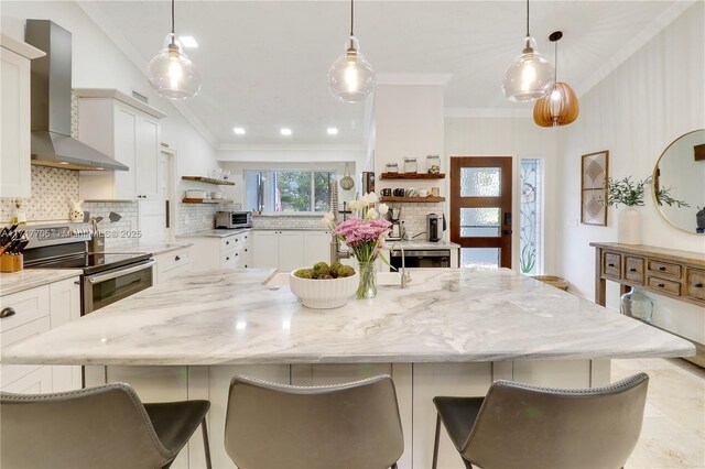 kitchen with a center island, decorative backsplash, electric stove, wall chimney exhaust hood, and open shelves