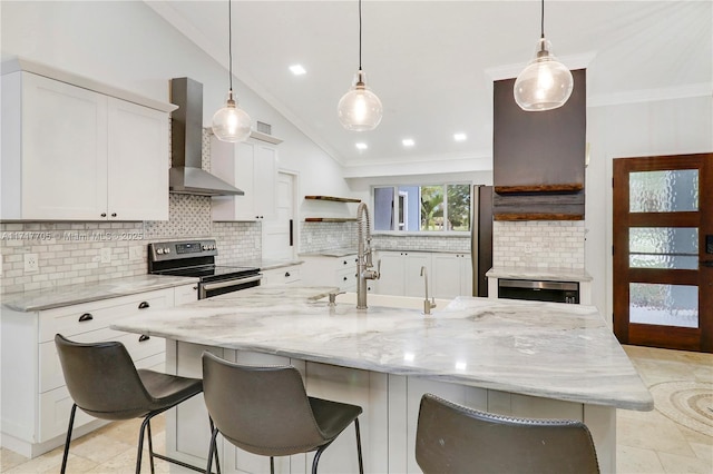 kitchen featuring open shelves, lofted ceiling, stainless steel appliances, crown molding, and wall chimney exhaust hood