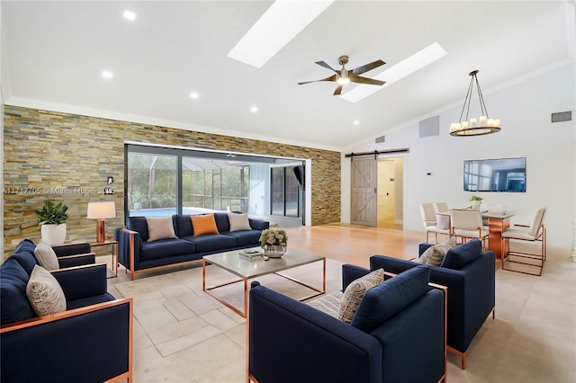 living area featuring a barn door, visible vents, and a skylight