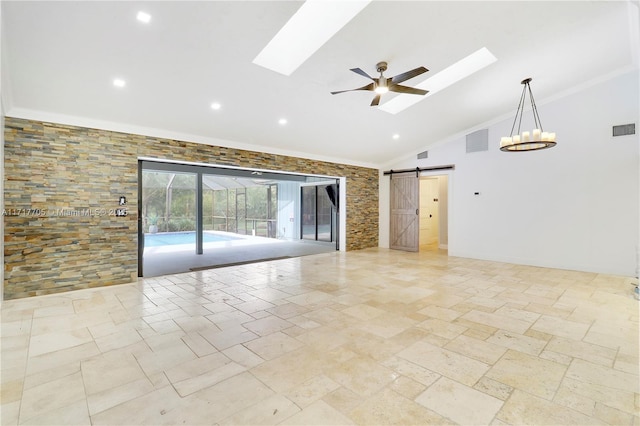 unfurnished room featuring a barn door, a skylight, and visible vents