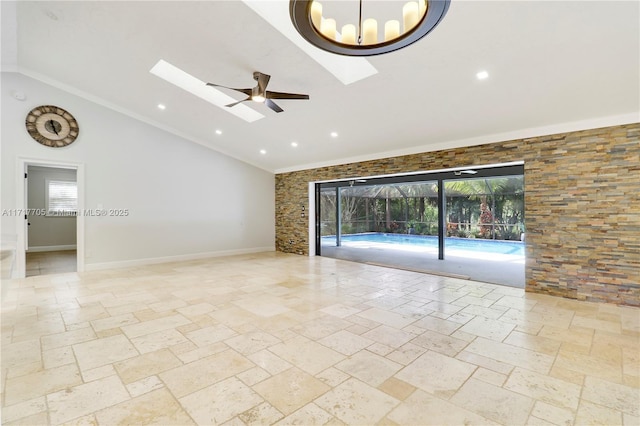 unfurnished room featuring stone tile floors, a healthy amount of sunlight, baseboards, and ceiling fan