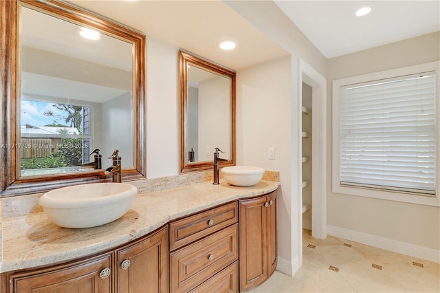 full bath with double vanity, tile patterned flooring, recessed lighting, and a sink