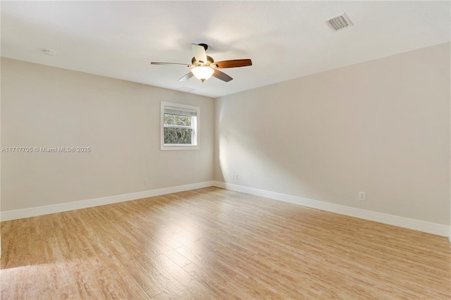 unfurnished room featuring visible vents, light wood-style flooring, baseboards, and ceiling fan